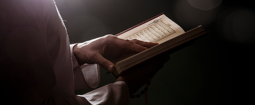 A man holding Qur'an the greatest miracle ever sent from God.